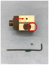Figure 7:  The bleed port is located on the negative port side and shown by the arrow and can be removed by using a small hex tool as depicted. The circled area indicates that this is the negative port of the transducer by the (-) symbol.